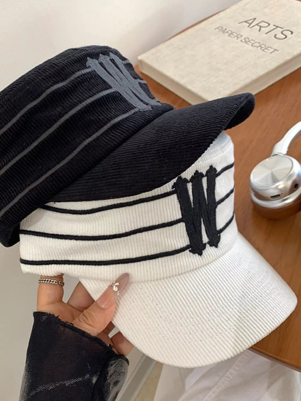 Striped cotton baseball cap in black and white with embroidered 'W' detail.
