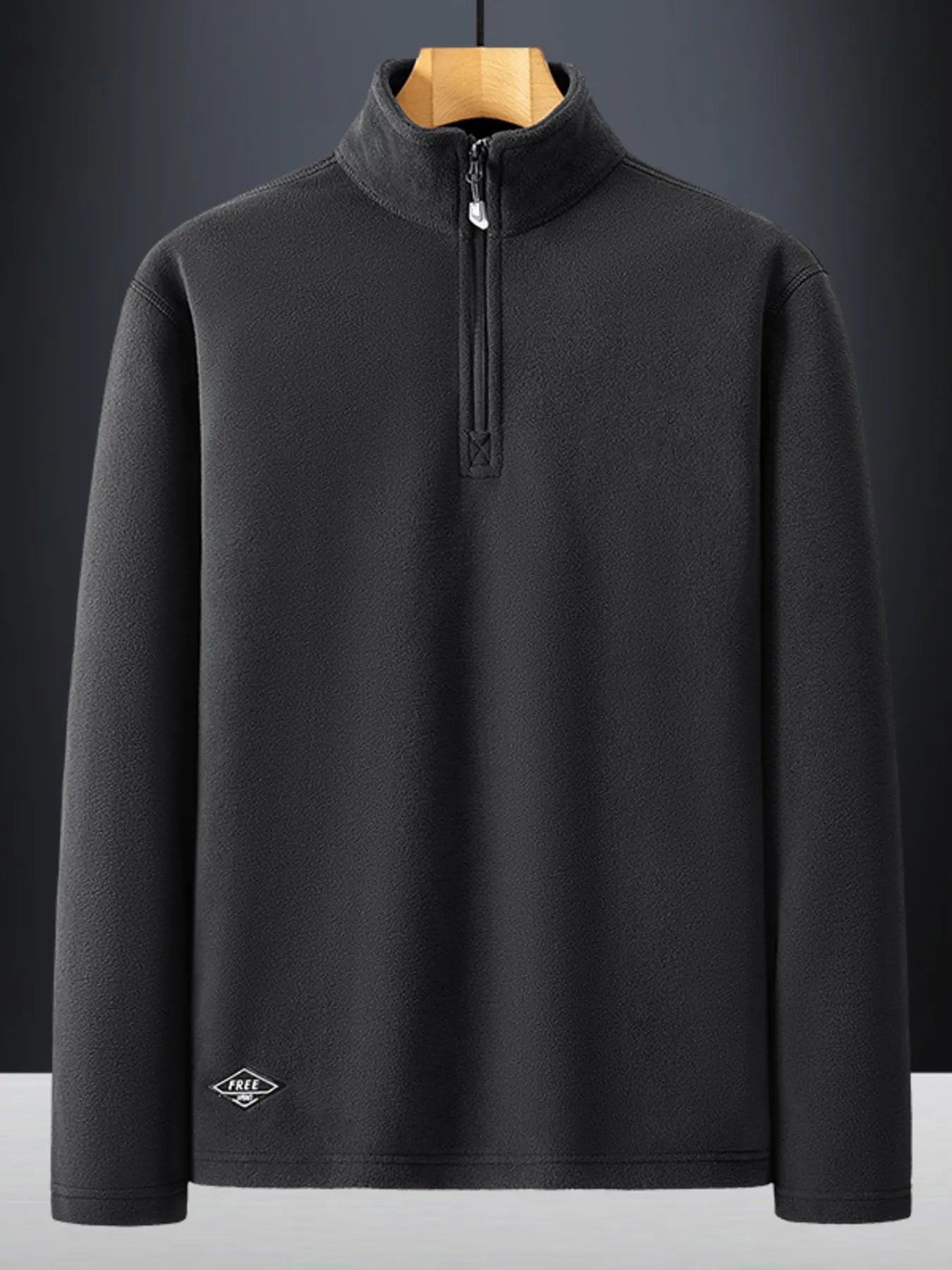 Dark Gray quarter zip sweatshirt with a mock neck and subtle logo detail.