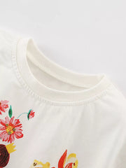 White cotton toddler t-shirt with colorful floral and fairy graphic print.