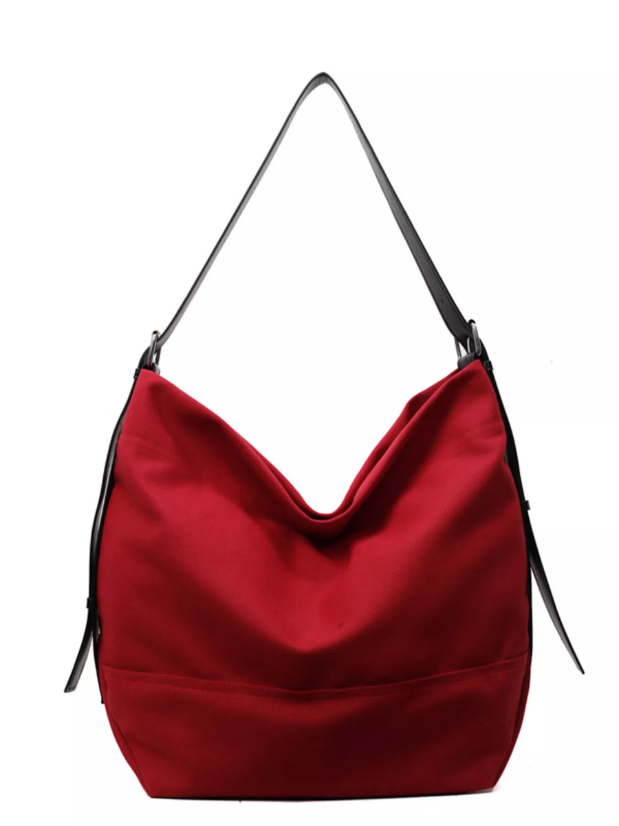Red hobo bag with adjustable strap and black trim
