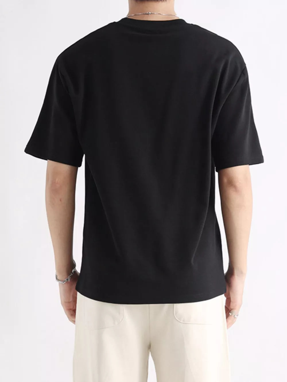 Men's black cotton t-shirt with relaxed fit and short sleeves.