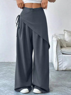Dark gray wide-leg pants with a wrap-style overlay and tie detail