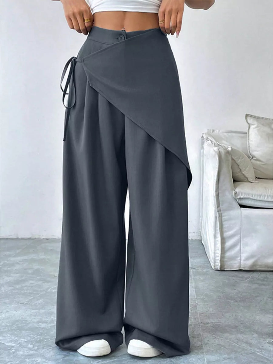 Dark gray wide-leg pants with a wrap-style overlay and tie detail