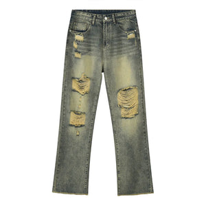 Distressed baggy jeans in medium wash cotton with shredded knees and raw hem.