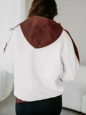 Hooded sweatshirt in dark brown and white patchwork with stripe detail on sleeves.