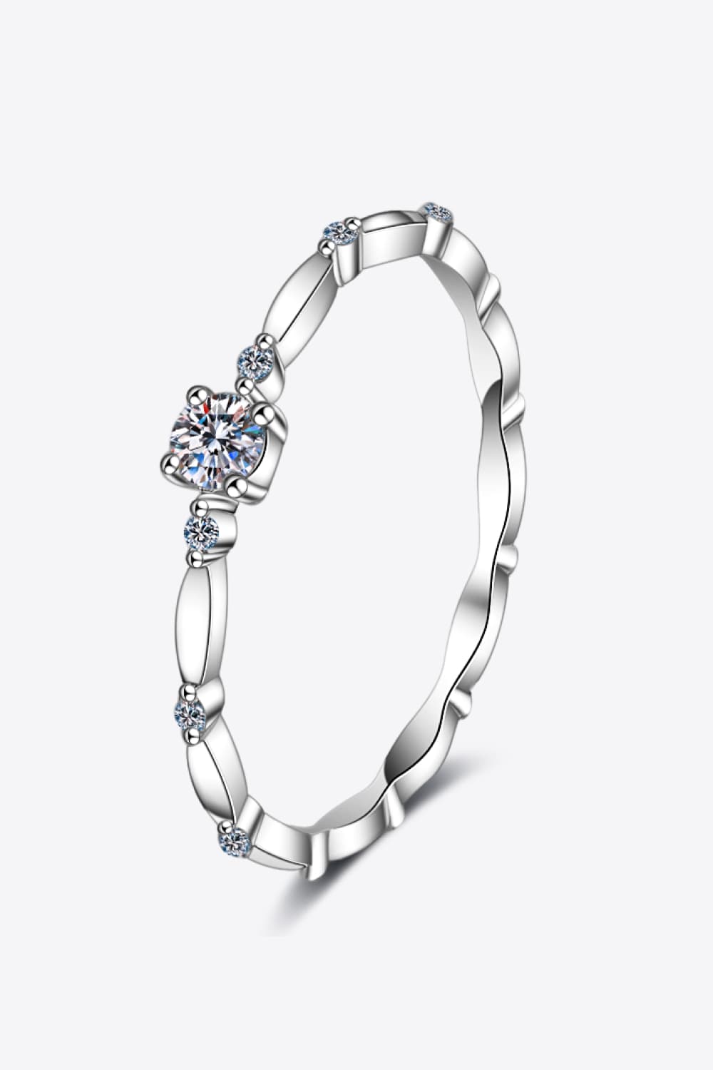 Delicate silver band ring with scalloped edges and small accent diamonds.