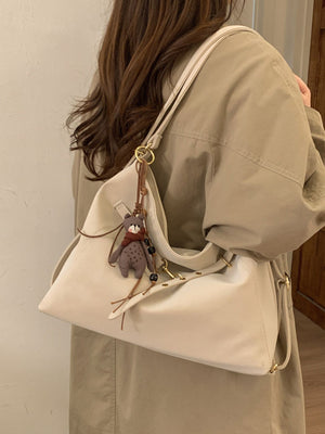 shoulder bag in ivory featuring gold-tone hardware and relaxed fit