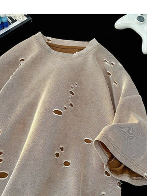 Oversized taupe cotton t-shirt with distressed holes and raw edges.