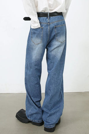 Medium wash denim trousers with a relaxed fit and vertical seams.