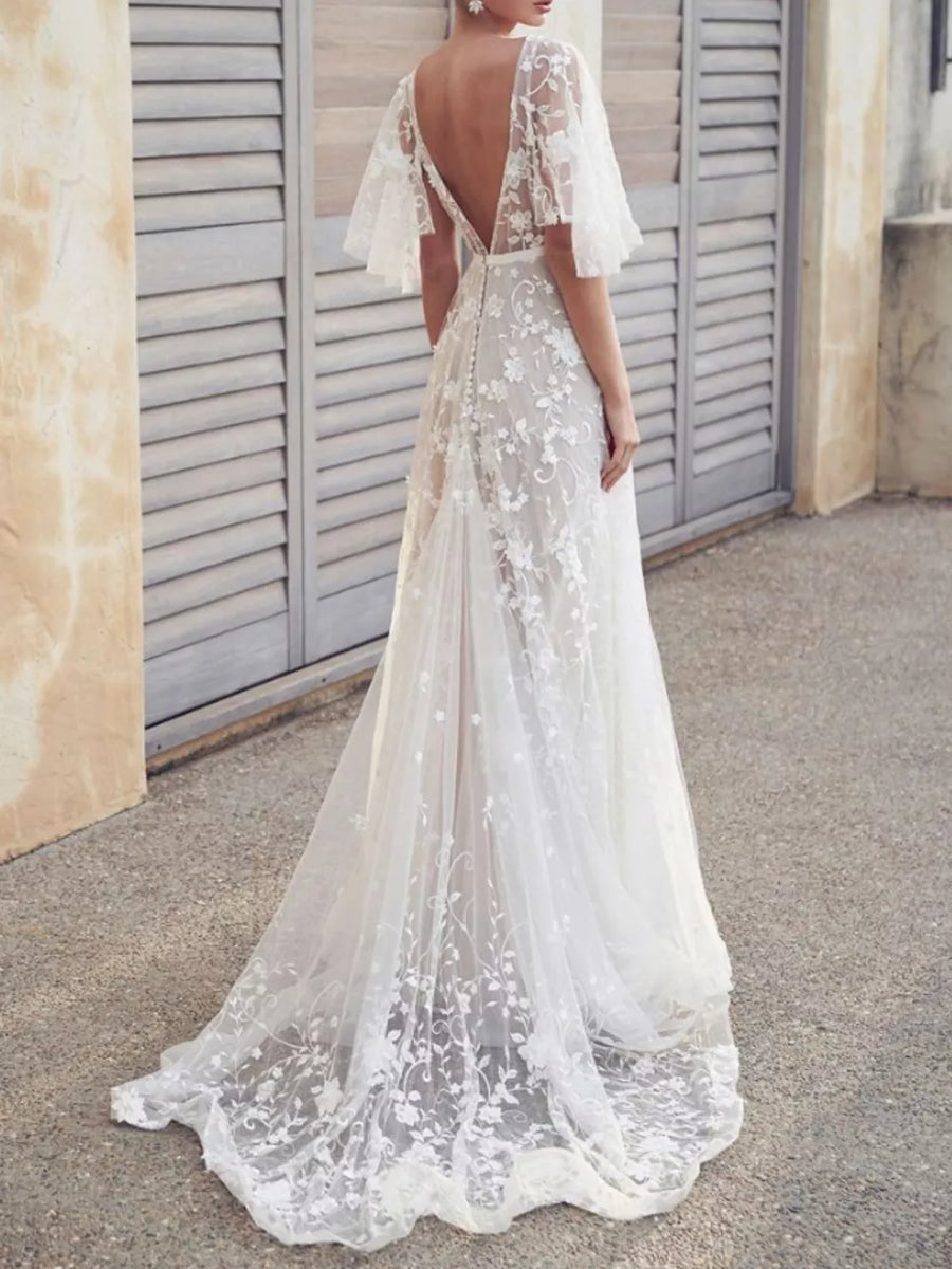 White lace flutter sleeve v-neck dress with floral embroidery and train.