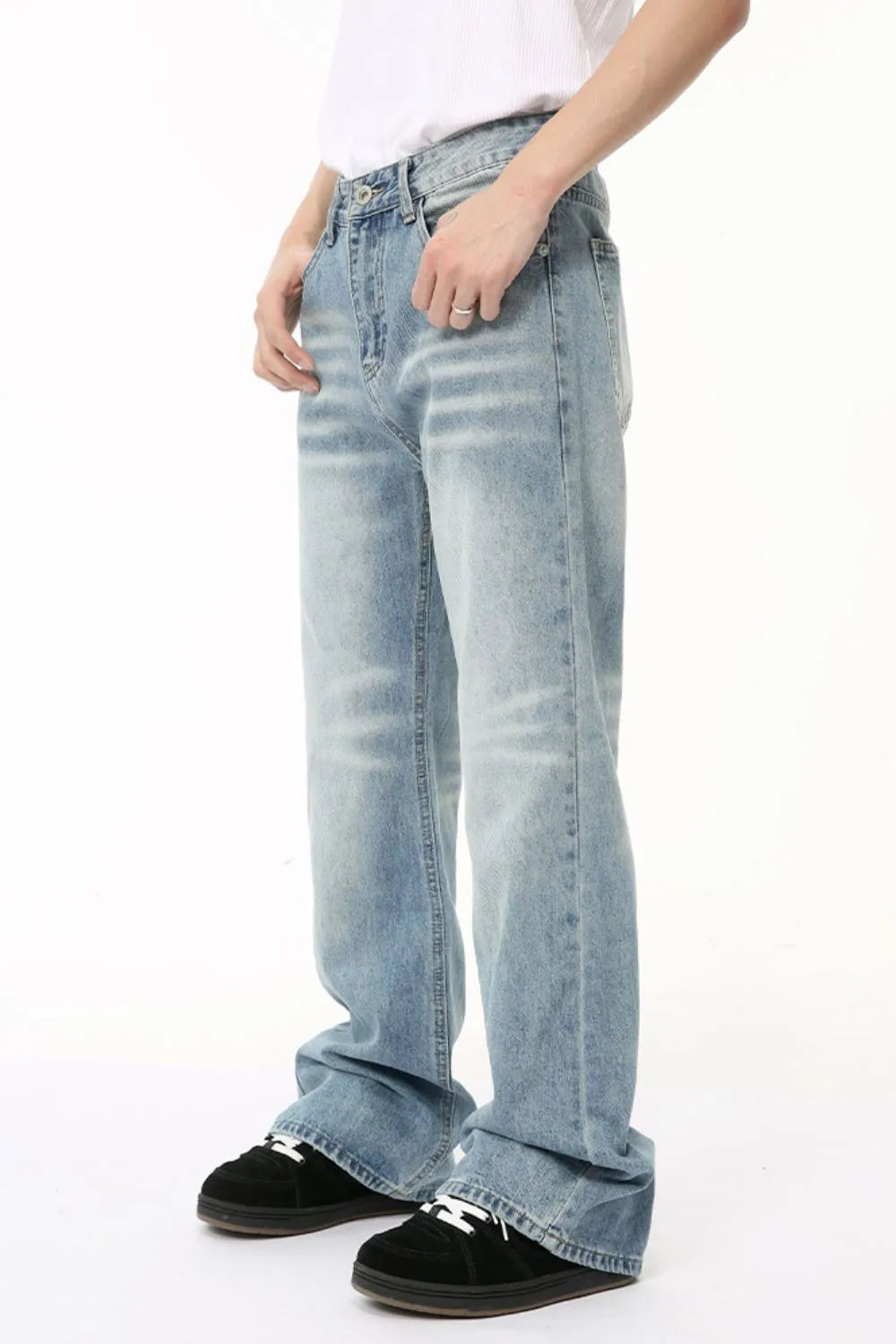 Wide leg washed denim trousers in medium blue, featuring a relaxed fit and casual styling.