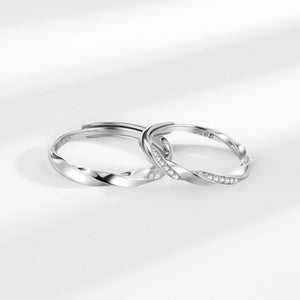 Adjustable sterling silver rings with twisted bands and cubic zirconia accents.