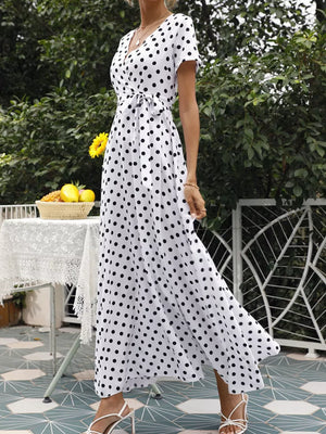 black wrap dress featuring belted and polka dot