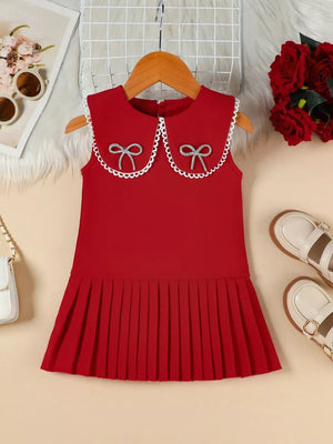 Red toddler dress with Peter Pan collar, lace trim, two bow details, and pleated skirt.