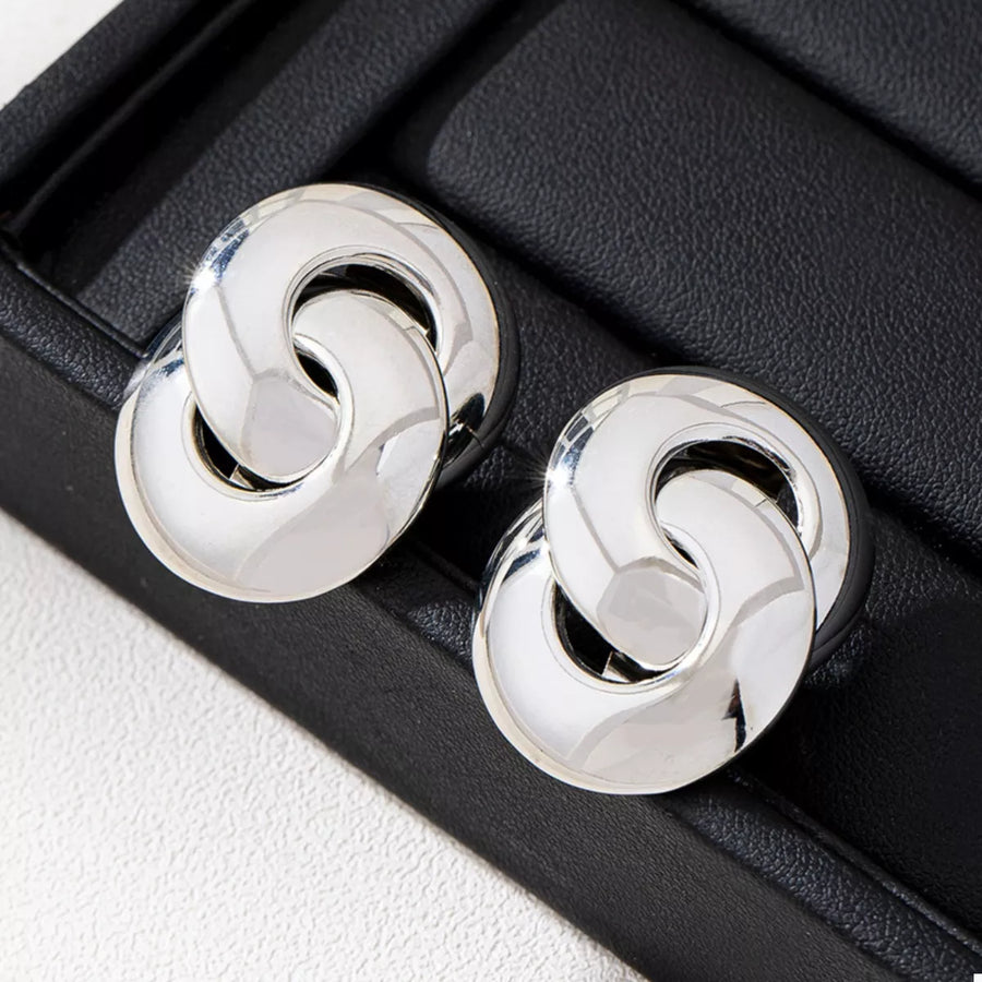Chunky knot earrings in silver, featuring interlocking circles with a polished finish.