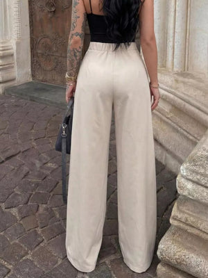 Elegant high-waisted wide-leg trousers in a light beige color, featuring a relaxed fit.
