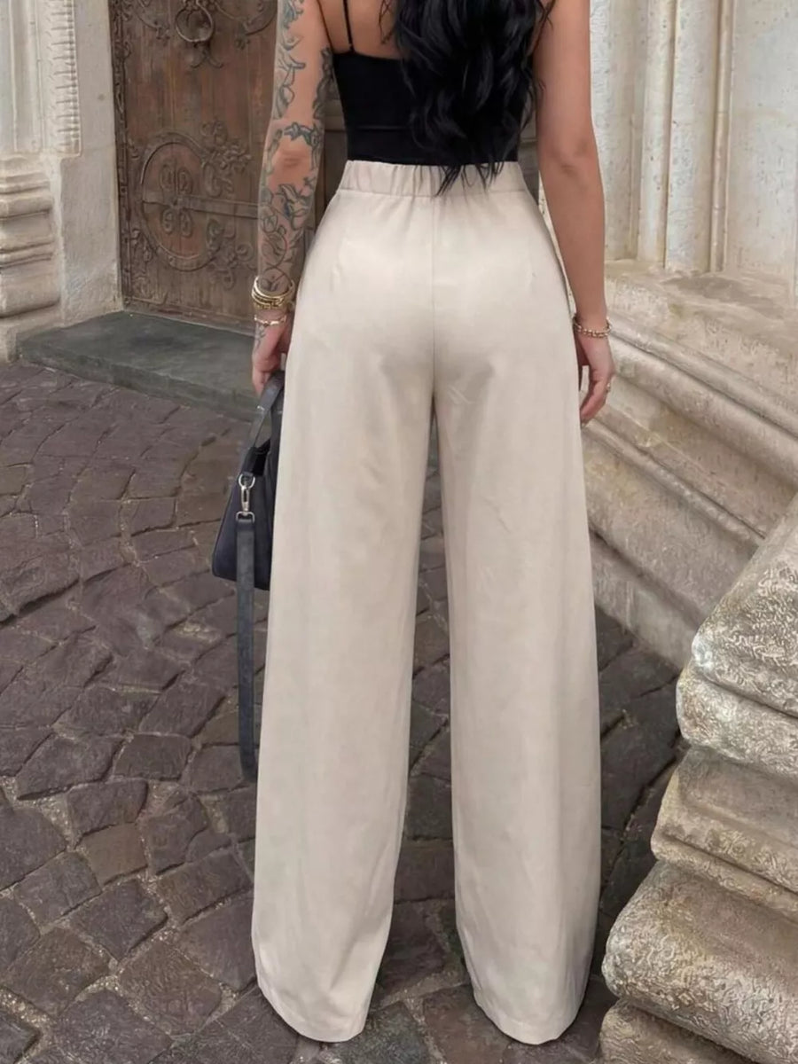 Elegant high-waisted wide-leg trousers in a light beige color, featuring a relaxed fit.