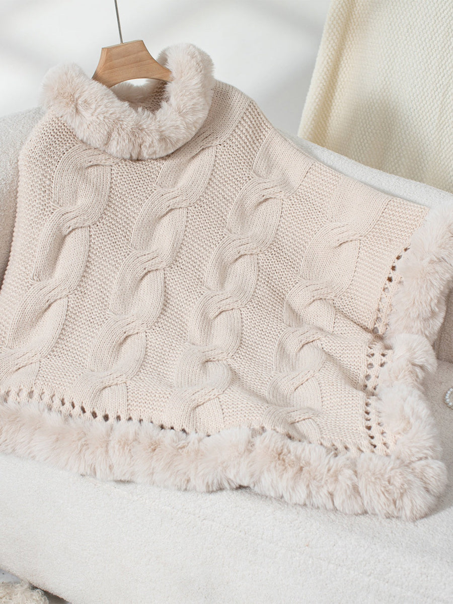Eggshell cable knit poncho with faux fur trim and turtleneck detail.