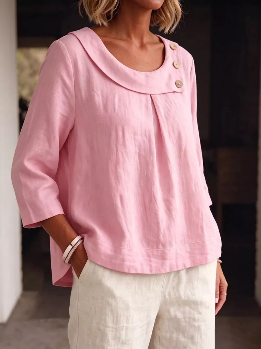 blouse in blush pink featuring decorative buttons and relaxed fit