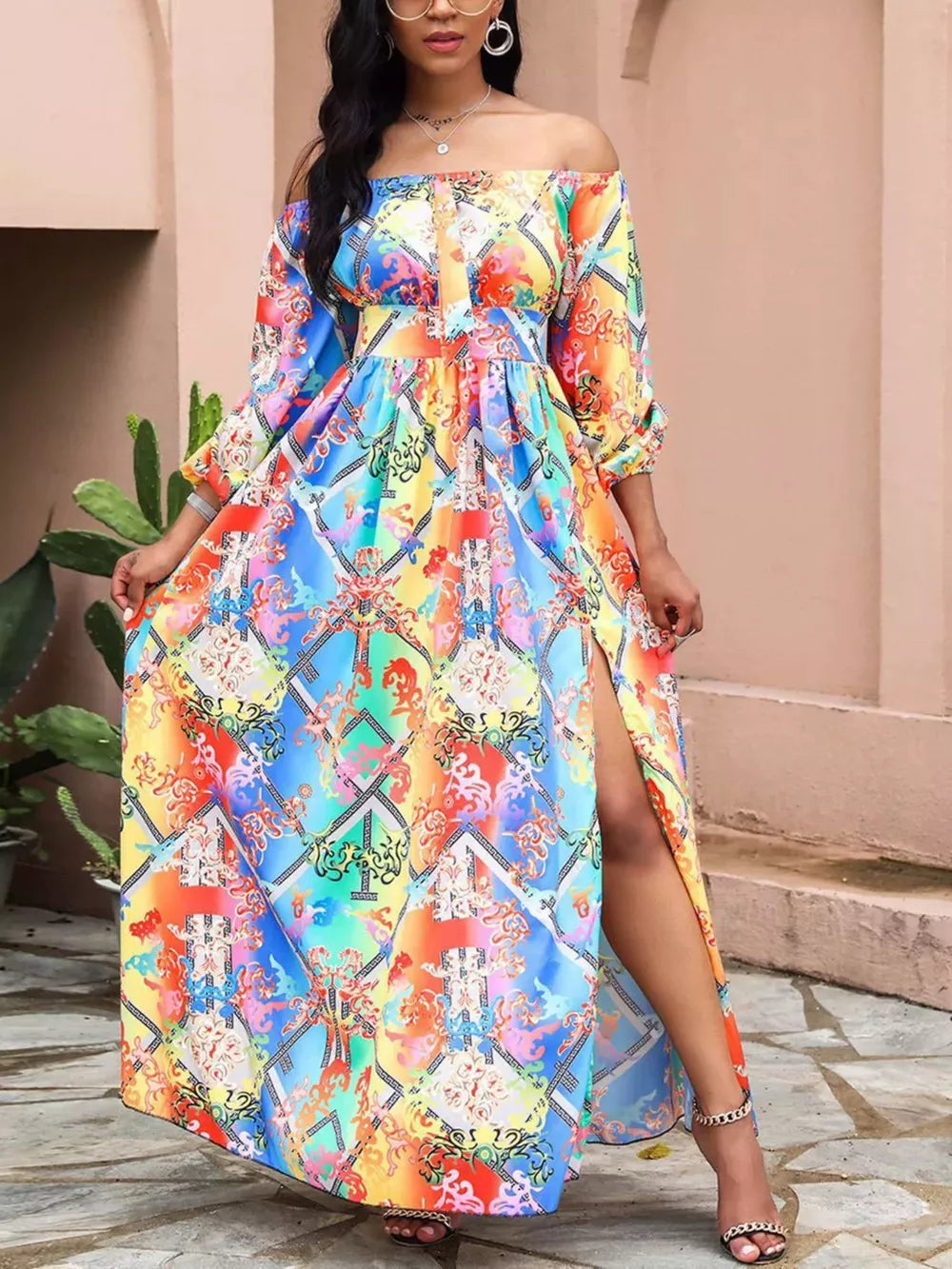 Vibrant off-shoulder maxi dress with baroque print and high slit.