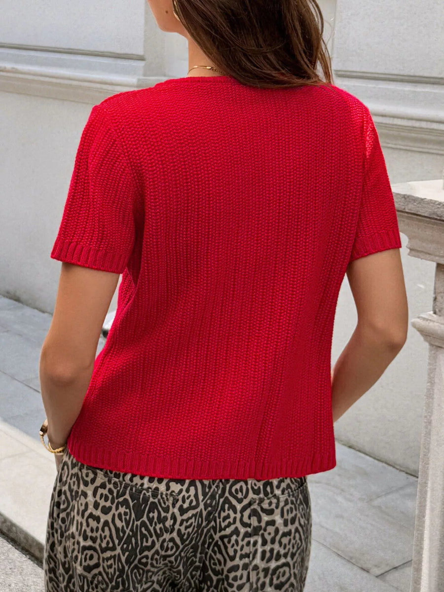 Red short-sleeve buttoned cardigan with a textured knit and crew neck.