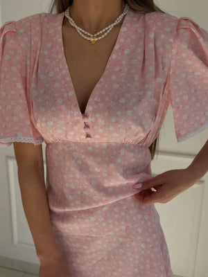 Pink floral print dress with v-neck, short sleeves, and button detail