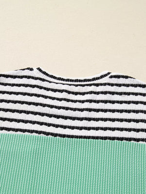 Turquoise and black striped ribbed long-sleeve top with a crew neck.