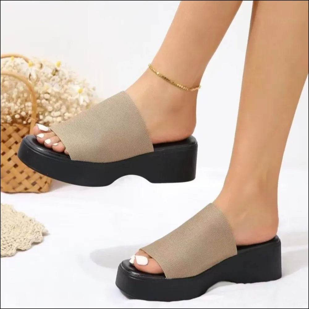 Khaki knit platform slide sandals with black soles.
