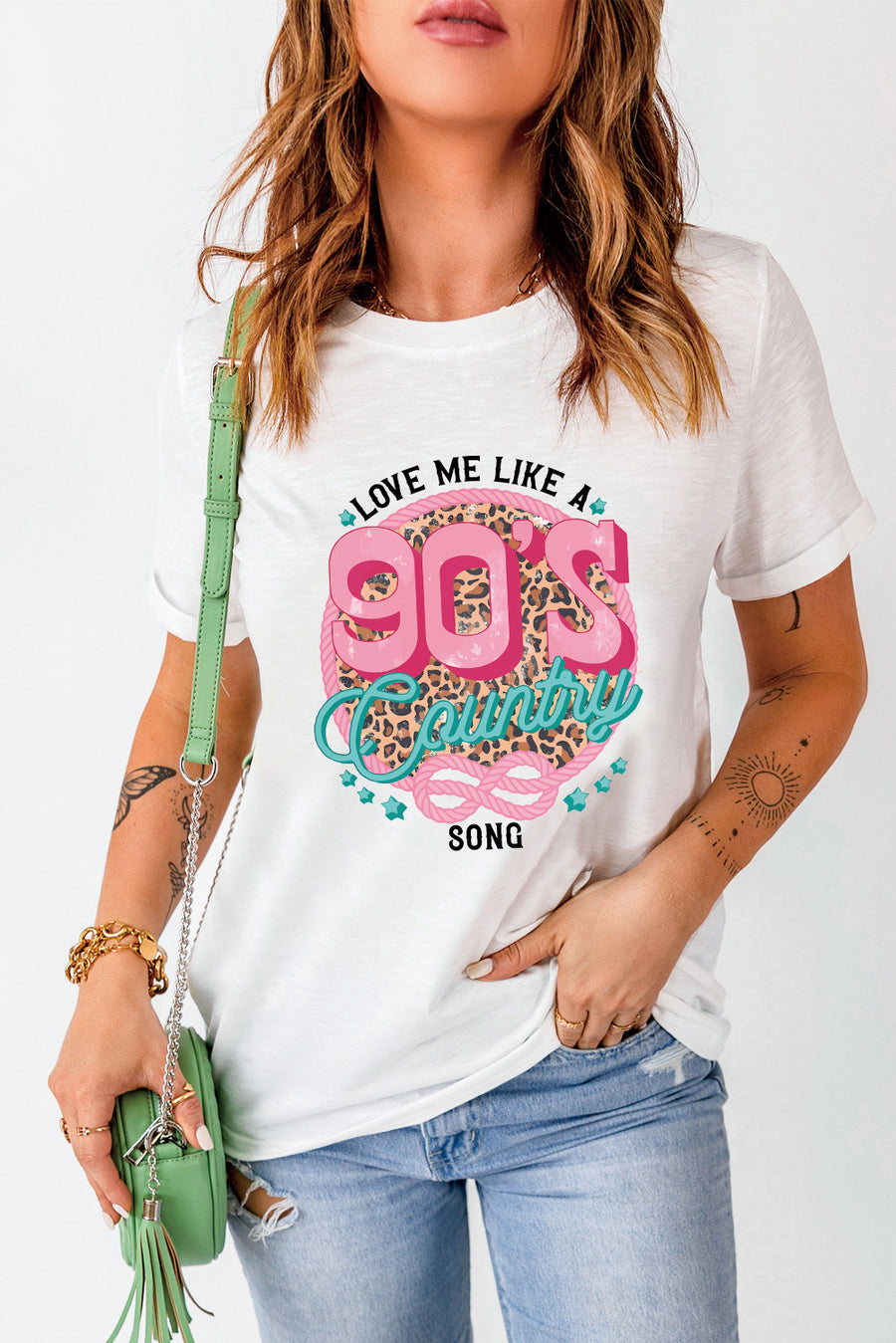 White graphic t-shirt with 90s country song design and leopard print detail.