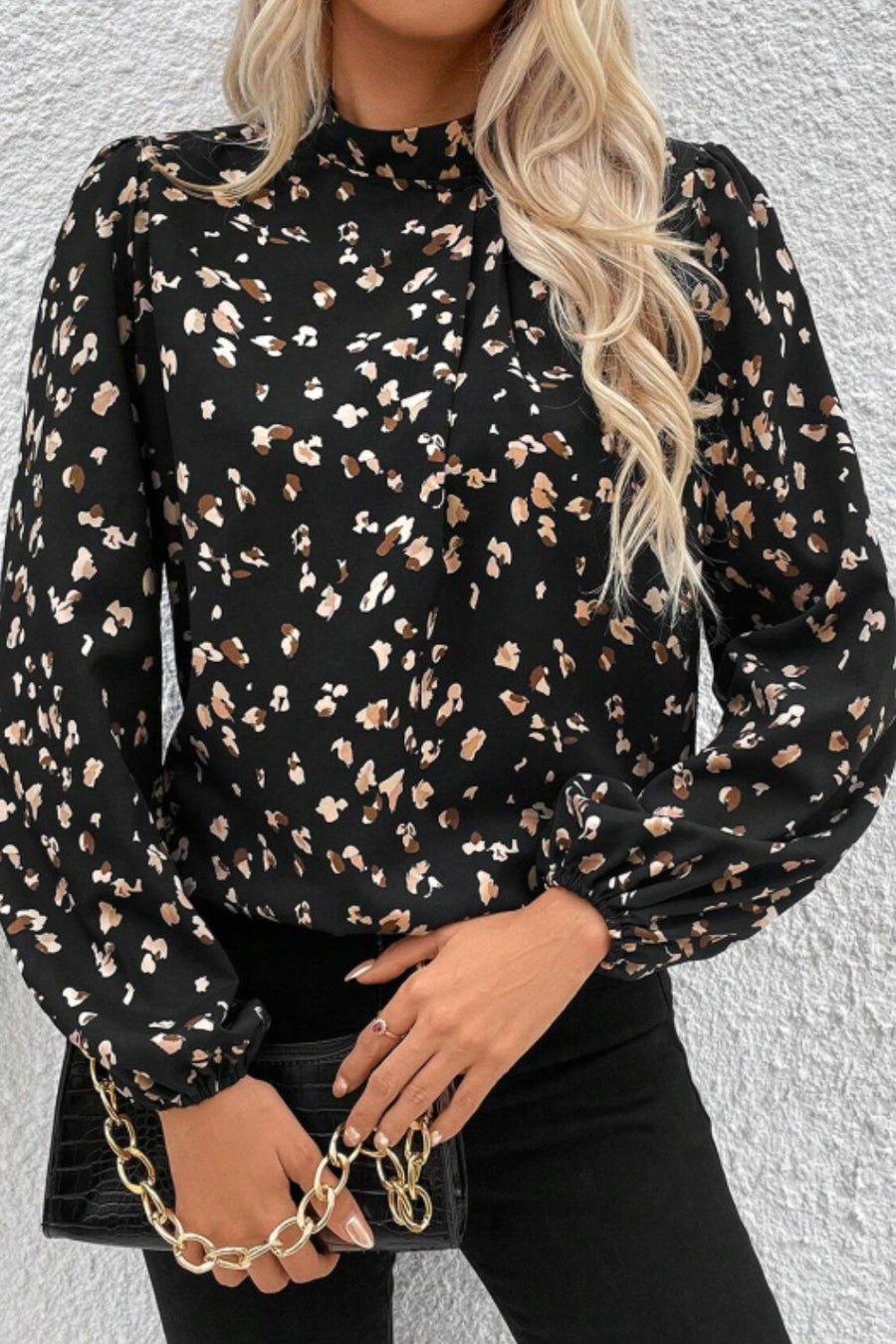 Black abstract print high-neck blouse with long puff sleeves.