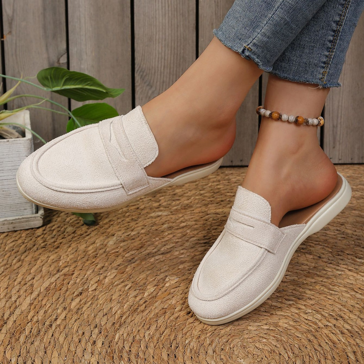Textured round toe slip-on loafers in a light beige color with a backless design.