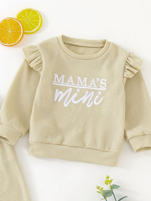 Toddler waffle knit top with ruffled sleeves and "Mama's Mini" embroidery in apricot.