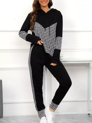 Black houndstooth hoodie and pants set with drawstring and chevron detail.