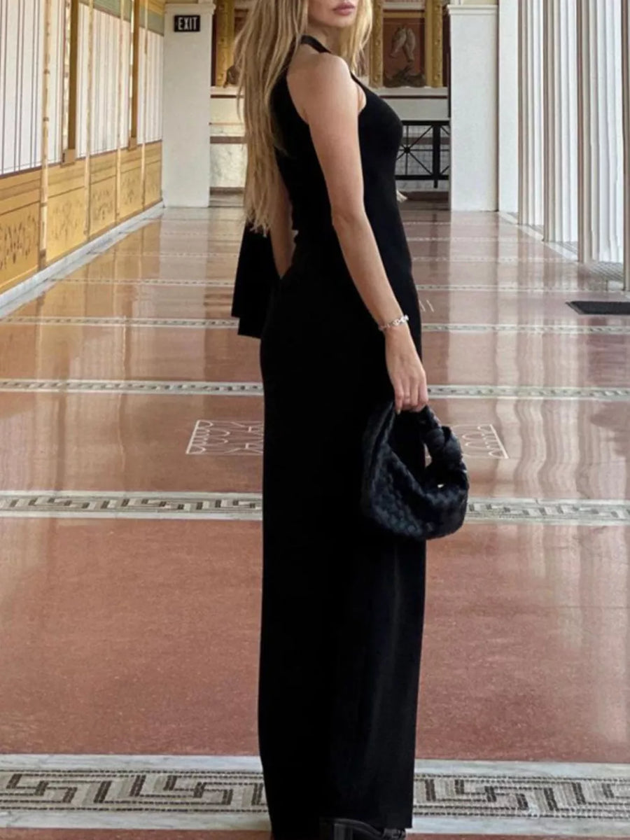 Black asymmetrical draped maxi dress with halter neckline.
