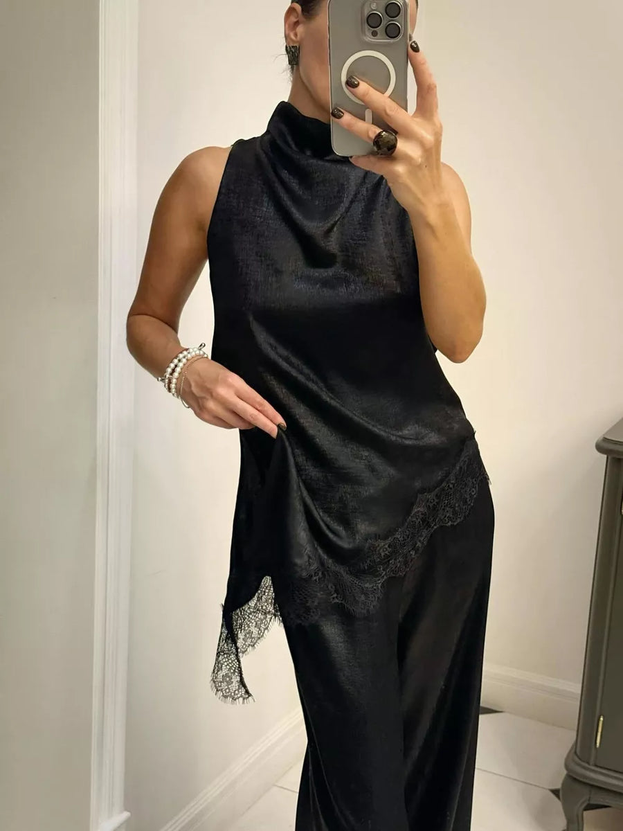 Black asymmetrical lace trim cami top with a mock neck and sleeveless design.
