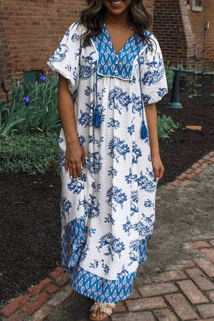 White and blue floral boho midi dress with tassel ties and short sleeves.