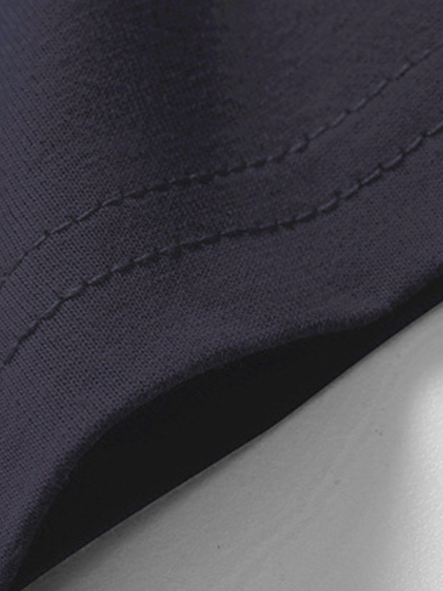 Blue cotton t-shirt detail showing stitching and fabric texture.