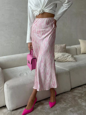 Satin midi skirt with pink and white zebra print, bias cut, and slight flare.