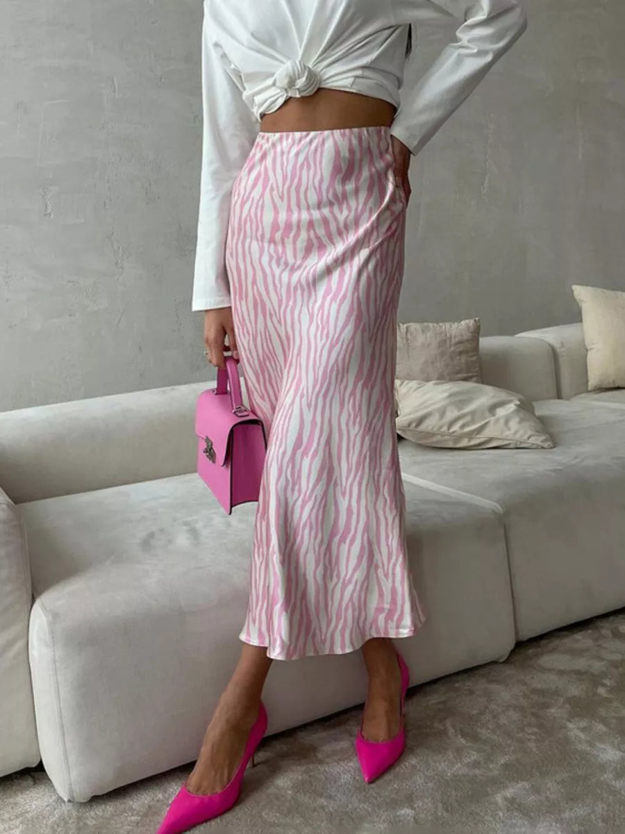 Satin midi skirt with pink and white zebra print, bias cut, and slight flare.