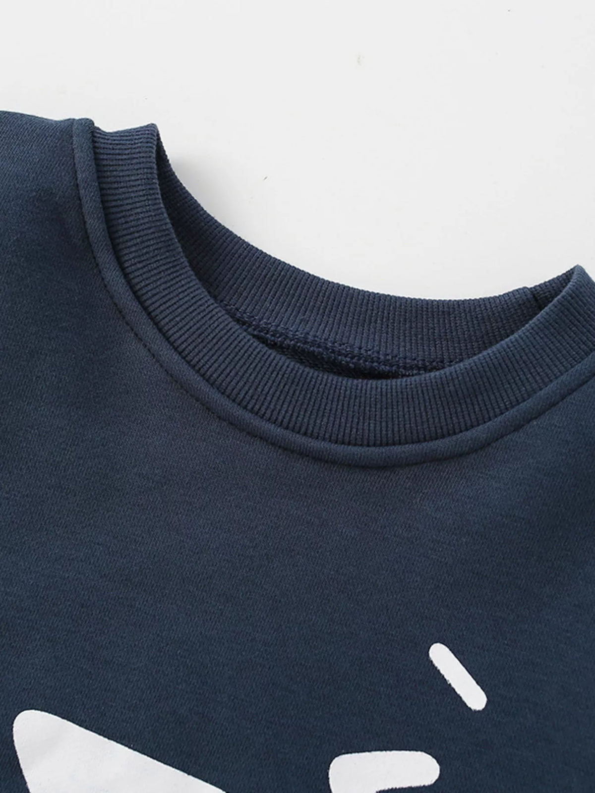 Dark navy crew-neck sweatshirt with white cartoon graphic and ribbed collar.