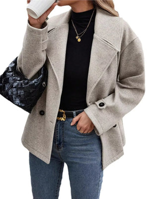 Light gray double-breasted wool blend pea coat with black buttons and notched lapels.