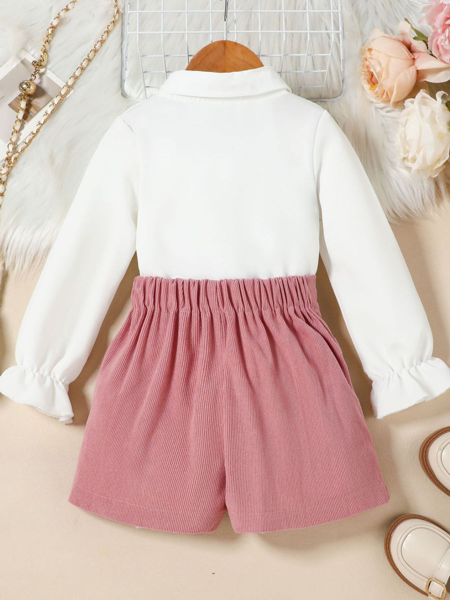Toddler white flounce sleeve shirt with pink corduroy skort set.
