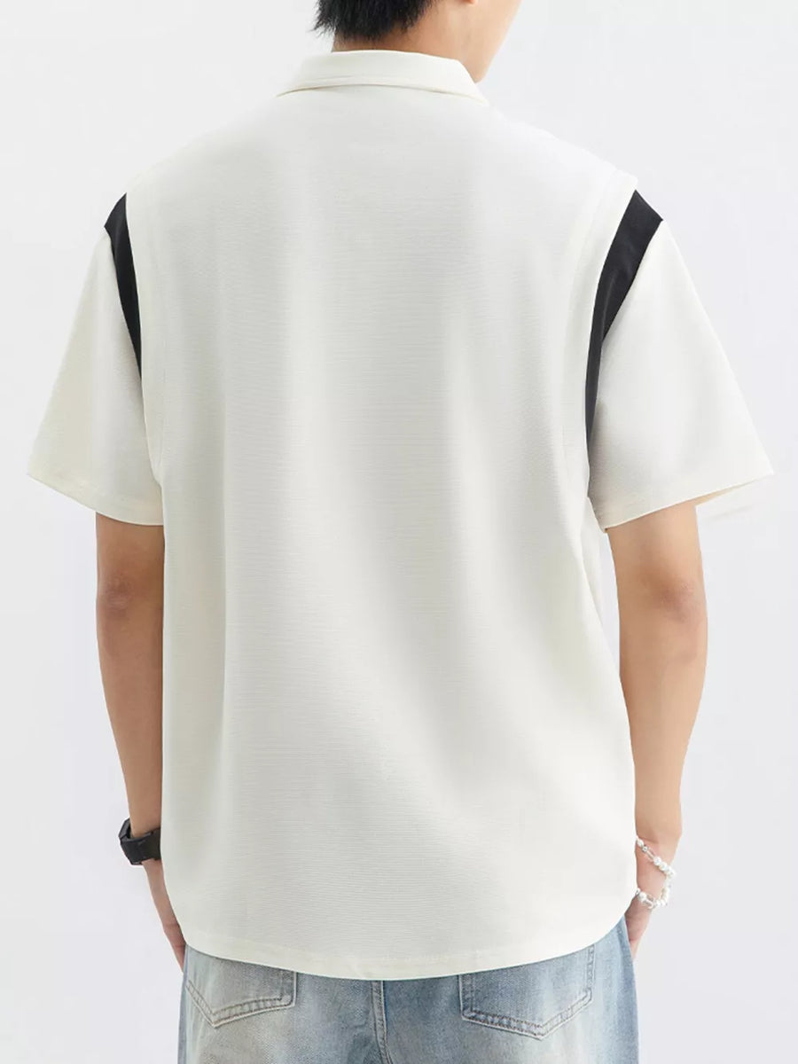 Men's beige cotton polo shirt with contrast black shoulder panels and textured fabric.