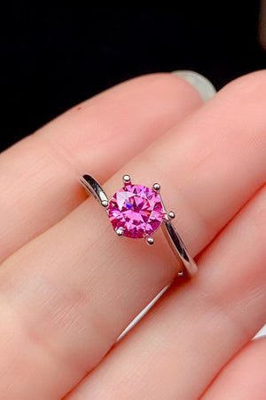 Radiant pink moissanite solitaire ring with a silver band.