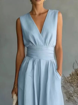 Light blue sleeveless V-neck midi dress with wrap bodice, belted waist, and pockets.