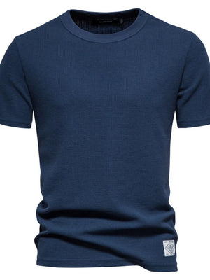 Navy textured crew-neck t-shirt knit with short sleeves and a small patch detail.