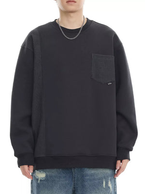Dark gray sweatshirt with textured side panel and chest pocket, crewneck, long sleeves.