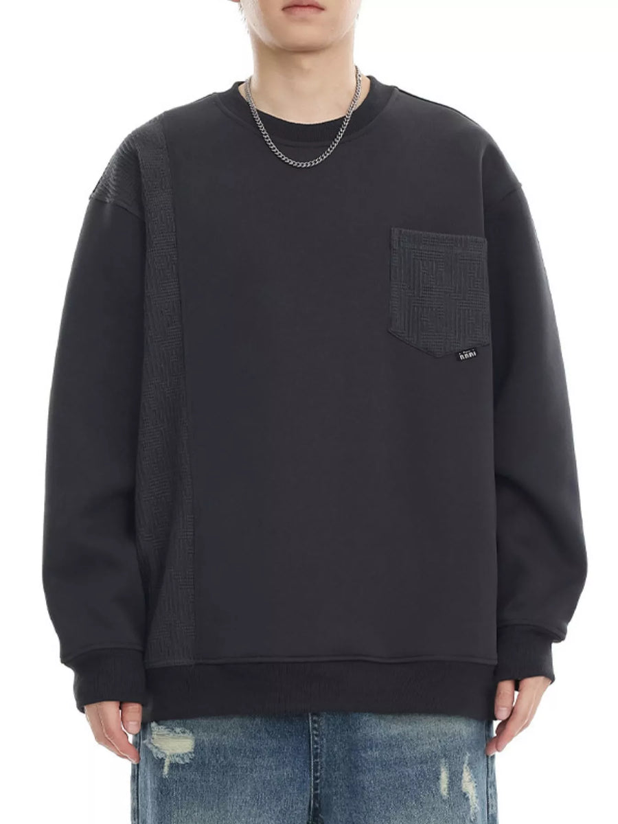 Dark gray sweatshirt with textured side panel and chest pocket, crewneck, long sleeves.