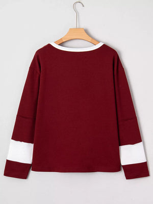 Burgundy long sleeve top with white trim and sleeve details