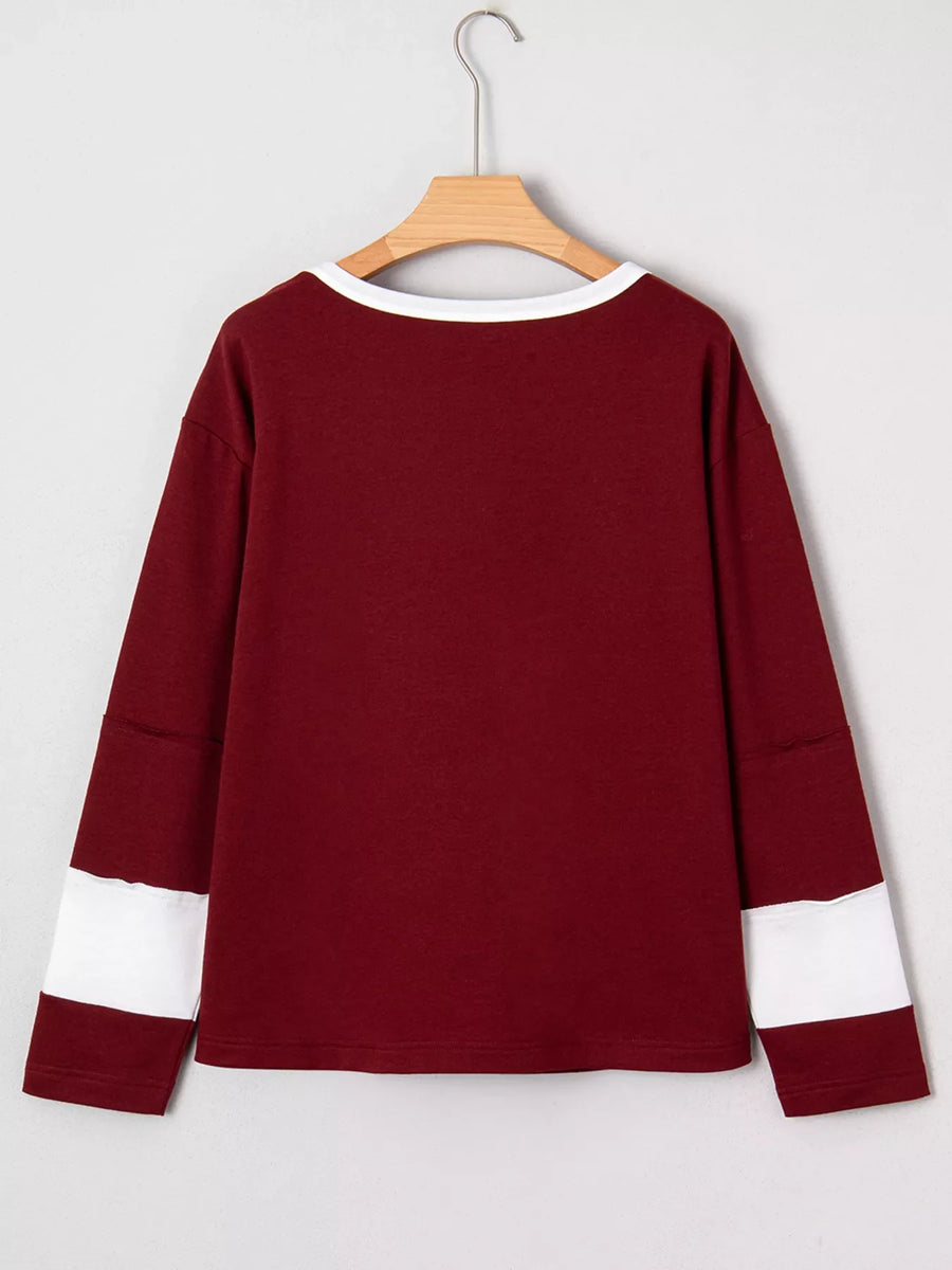 Burgundy long sleeve top with white trim and sleeve details